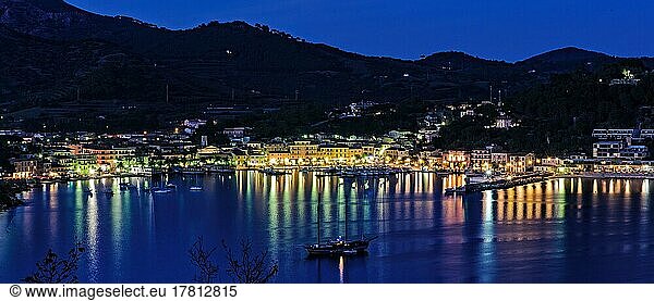 Panoramic view of Porto Azzurro with illuminated harbour promenade in the evening mood during blue hour  Porto Azzurro  Elba  Tuscany  Italy  Europe
