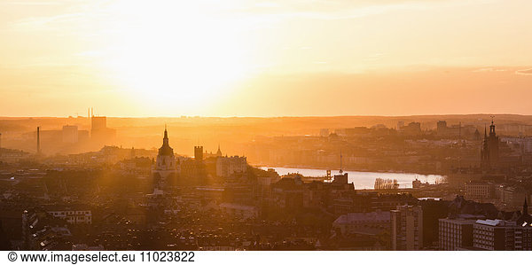 Panoramic view of residential district against orange sky during sunset