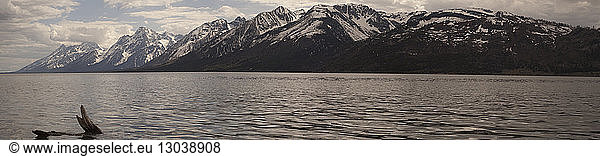 Panoramic view of sea and snowcapped mountain against sky