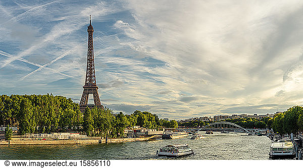 Panoramic view of the Eiffel tower and boats on the Seine river