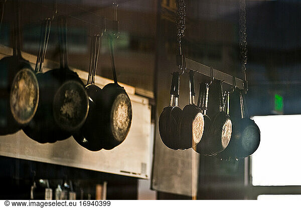 Pans hanging in commerical kitchen.