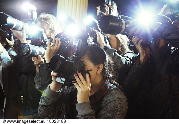 Paparazzi photographers photographing event