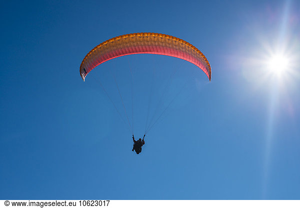 Paraglider in blue sky