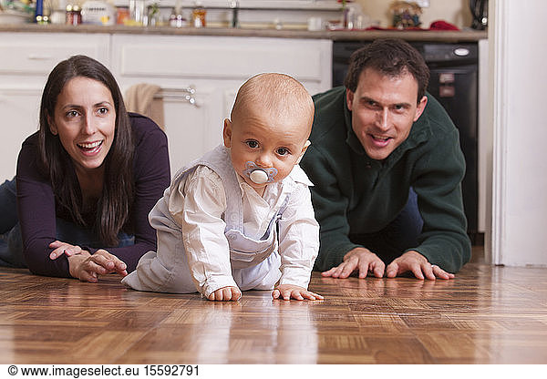 Parents playing on the floor with their son