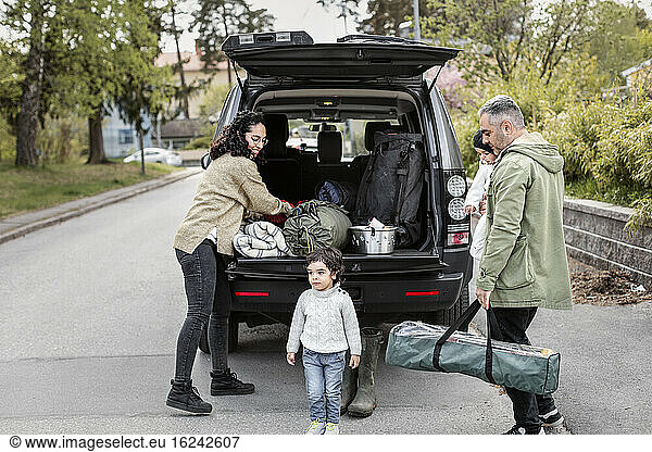 Parents with children near car