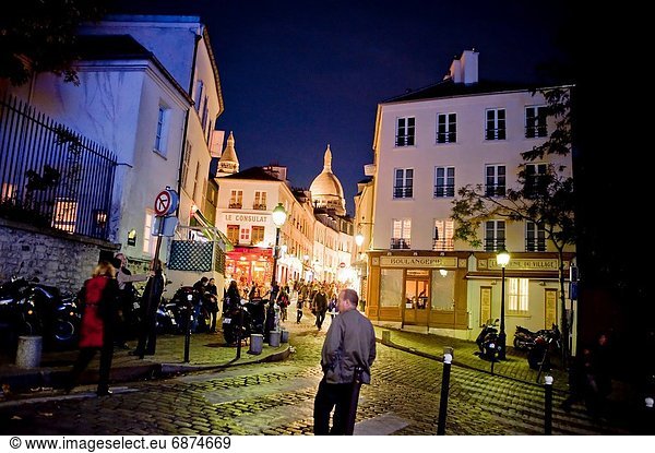 Paris  France  Street Scene  Old Buildings  at Night  with French Bakery Shop  Boulangerie  in Montmartre District