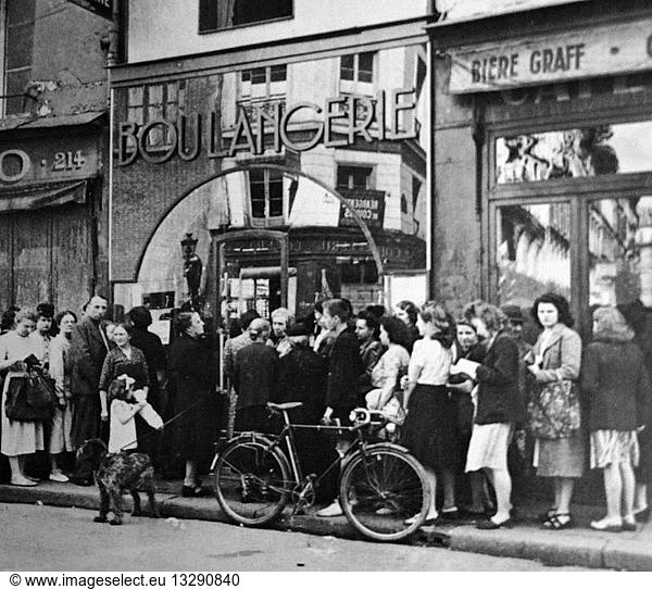 Parisians queue at a boulangerie (bakers) in Paris during the German occupation in World war two 1941