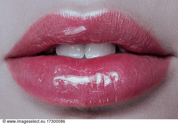 Part of face young woman close up. plump glossy lips