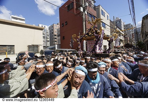 Participants carry a Mikoshi (portable shrine) during the Sanja Matsuri in Asakusa district on May 20  2018  Tokyo  Japan. The Sanja Matsuri is one of the largest Shinto festivals in Tokyo  and it is held in Tokyo's Asakusa district for three days around the third weekend of May. Large groups of people dressed up traditional clothes carry Mikoshi (sacred portable shrines) between the streets near to Sensoji Temple to bring blessing and fortune to the inhabitants of the neighboring community at Asakusa during the second and third day of the festival. The annual festival attracts millions of visitors every year.