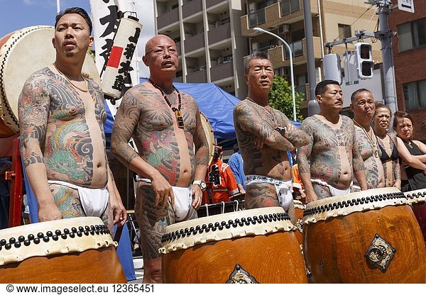 Participants showing their full body tattooed  possibly members of the Japanese mafia or Yakuza  attend the Sanja Matsuri in Asakusa district on May 20  2018  Tokyo  Japan. The Sanja Matsuri is one of the largest Shinto festivals in Tokyo  and it is held in Tokyo's Asakusa district for three days around the third weekend of May. Large groups of people dressed up traditional clothes carry Mikoshi (sacred portable shrines) between the streets near to Sensoji Temple to bring blessing and fortune to the inhabitants of the neighboring community at Asakusa during the second and third day of the festival. The annual festival attracts millions of visitors every year.