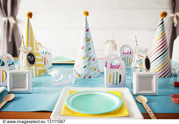 Party hats on decorated table during birthday party