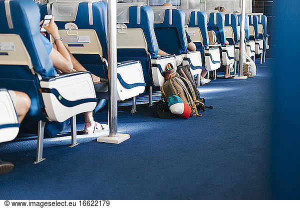 Passengers sitting on seats in cruise ship