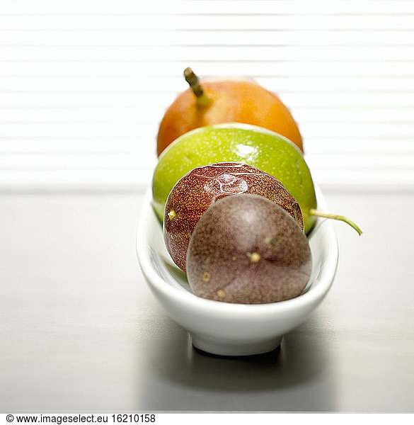 Passion fruits and grenadilla in bowl