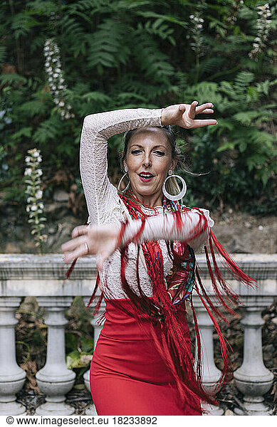 Passionate woman doing flamenco dance in front of railing