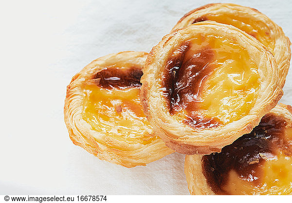 Pasteis de nata typical Portuguese dessert. White background and selective focus. Pastry concept