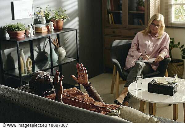 Patient explaining problems to senior psychologist at office
