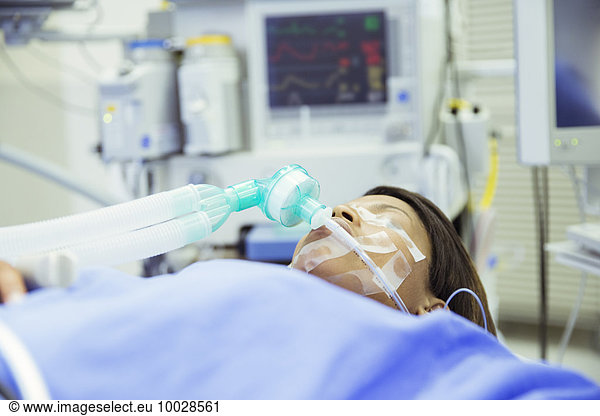 Patient with oxygen mask in operating room