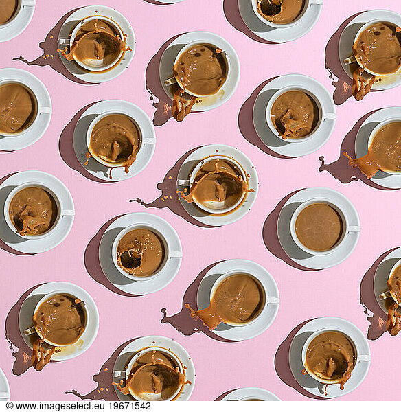 pattern if white cups with coffee of pink background. Coffeeâ??s cover