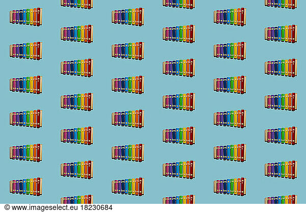 Pattern of colorful xylophones flat laid against blue background