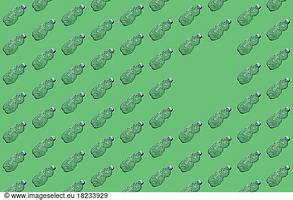 Pattern of rows of empty plastic bottles with single blank spot