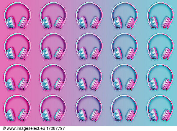 Pattern of rows of pink and blue wireless headphones