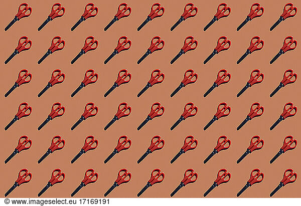 Pattern of rows of scissors against red background