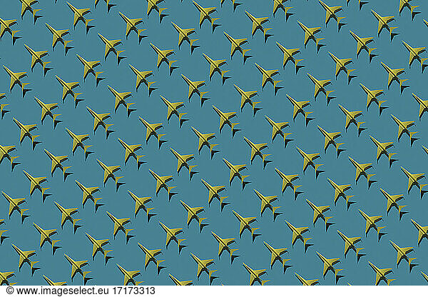 Pattern of yellow origami airplanes