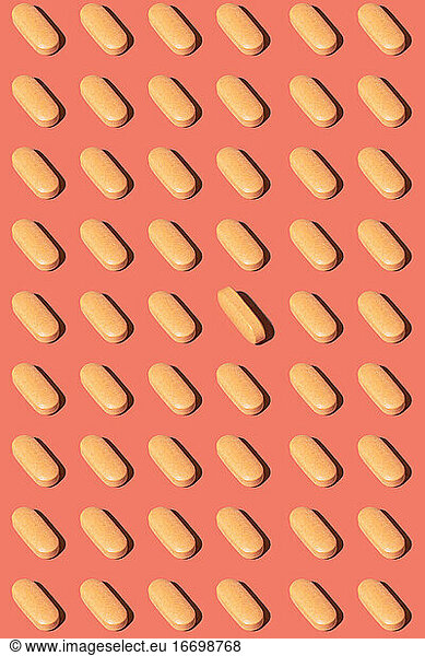 Pattern of Yellow Pills on pink yellow background