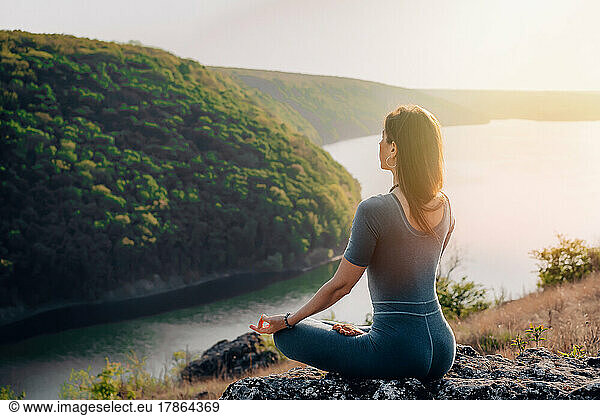 Peaceful yogi woman sitting in lotus  meditating  feeling free