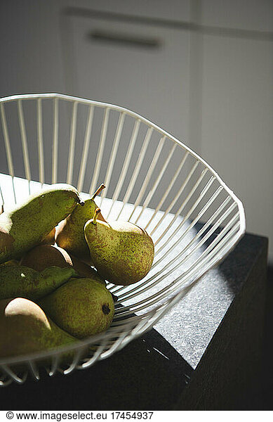 Pears in a bowl in the sun in the kitchen