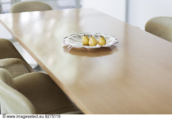 Pears in glass dish on dining table