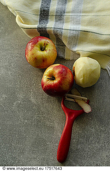 peeling red ripe apples for pie
