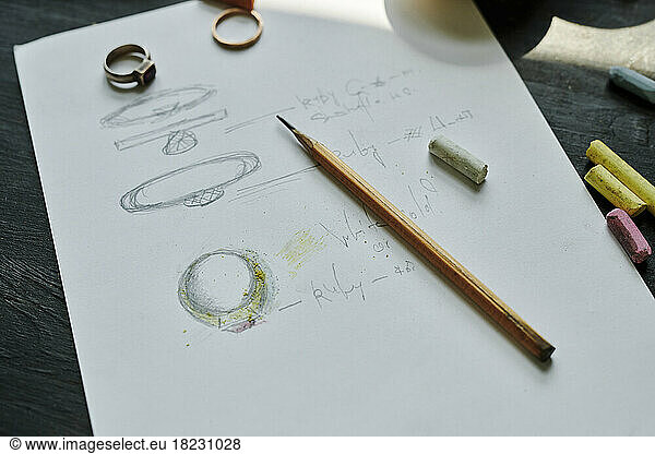 Pencil on paper with drawing of rings at workbench