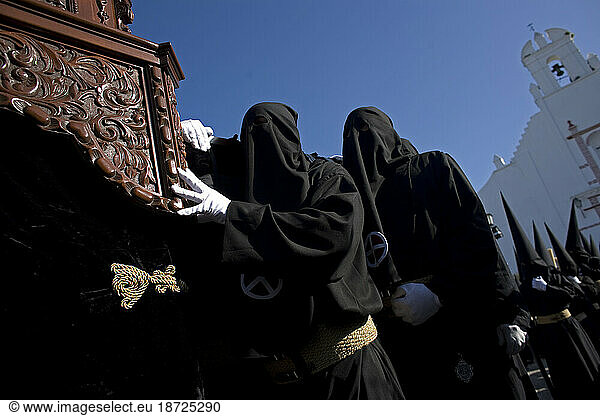 Penitents carry a throne during a procession for Easter Holy Week celebrations in Bornos village  Cadiz province  Andalusia  Spain