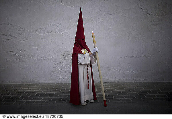 Penitents walk in a street during Easter Holy Week celebrations in Espera village  Cadiz province  Andalusia  Spain.
