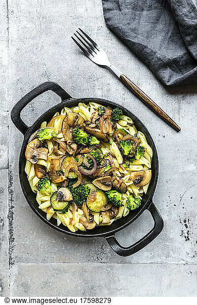 Penne pasta with mushrooms  broccoli  zucchini and onion