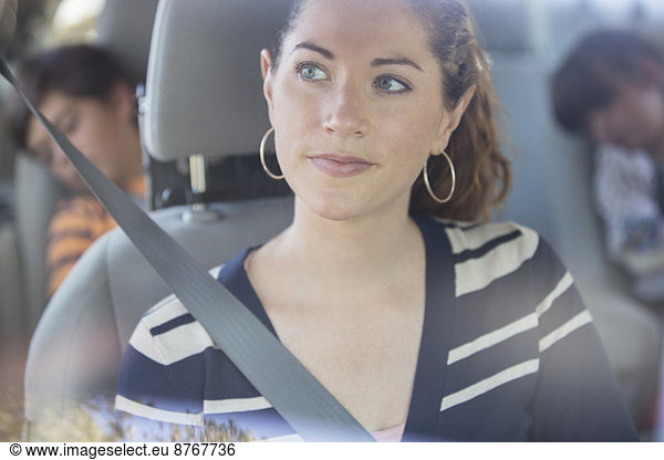 Pensive woman inside car