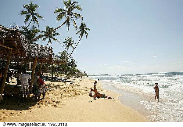 People at Hikkaduwa beach  Sri Lanka.