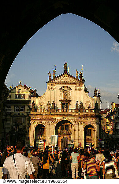 People at the end Of charles bridge infront of St. Salvator church. Prague  Czech Republic.