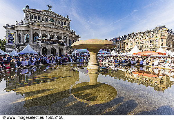 People at water fountain outside Frankfurt Old Opera House  Germany