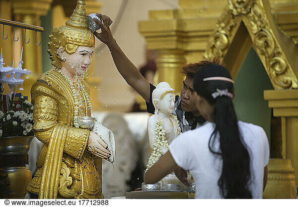People Bathing Or Splashing A Buddha Statue In Shwedagon Pagoda; Yangon  Burma