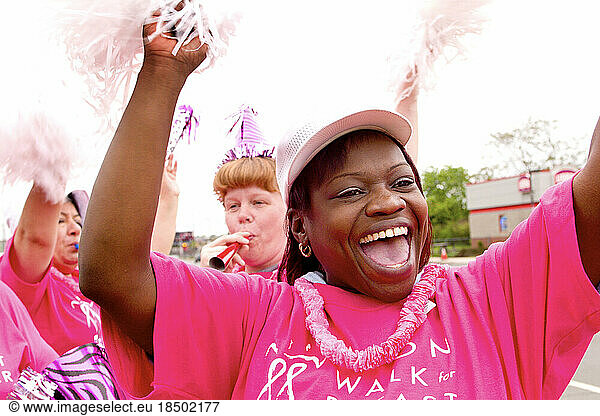 People cheer as breast cancer walk goes by in Boston.