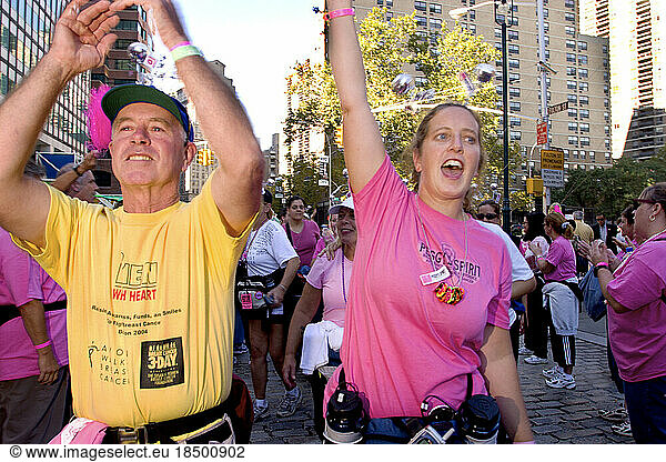 People cheer at the finish of the Avon Walk for Breast Cancer in New York City.