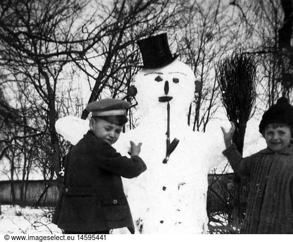 people  child / children  siblings  children building snowman  1920s