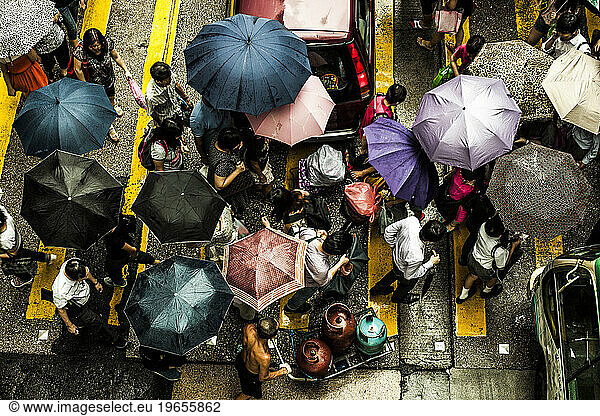 People crossing a street in the rain