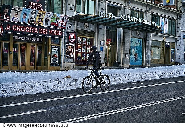 People cycling with snowy and empty Gran via Street on January 11  2021 in Madrid  Spain. Storm Filomena brought more than 50cm of snow to the Spanish capital  the most in decades.