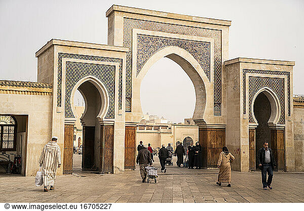 people entering and exiting one of Fez's gates in Morocco