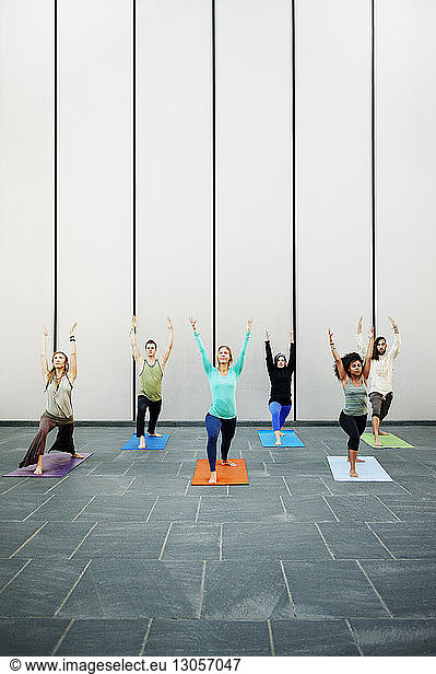 People exercising in yoga class