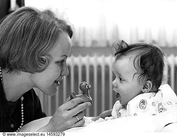 people  family  mother with son  daughter  mother playing with baby  1960s