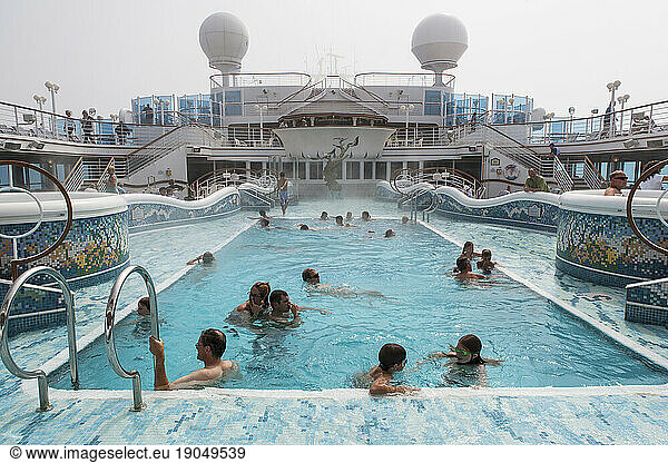 People in a swimming pool on cruise ship.